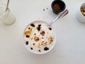 Oatmeal with Frothed Milk, Hazelnuts, Raisins, and Jaggery